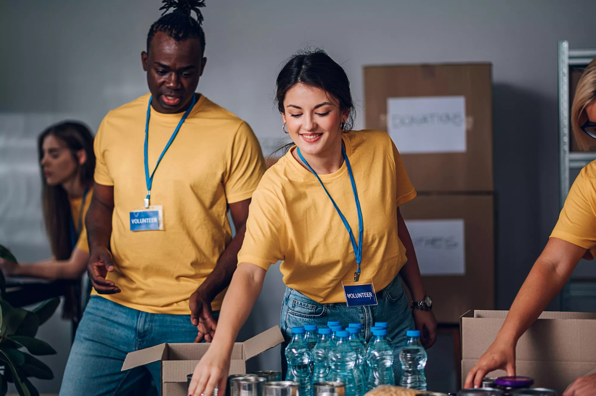 Group of multiracial volunteers working in community charity donation center